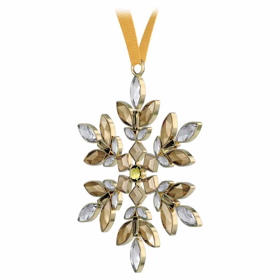 The Swarovski Gema Holiday Ornament Home Décor is an exquisite gold and silver snowflake ornament ideal for the holiday season. It hangs elegantly from a gold ribbon, showcasing symmetrical, leaf-like patterns with a small central yellow gemstone, capturing the sophistication synonymous with the Swarovski brand.