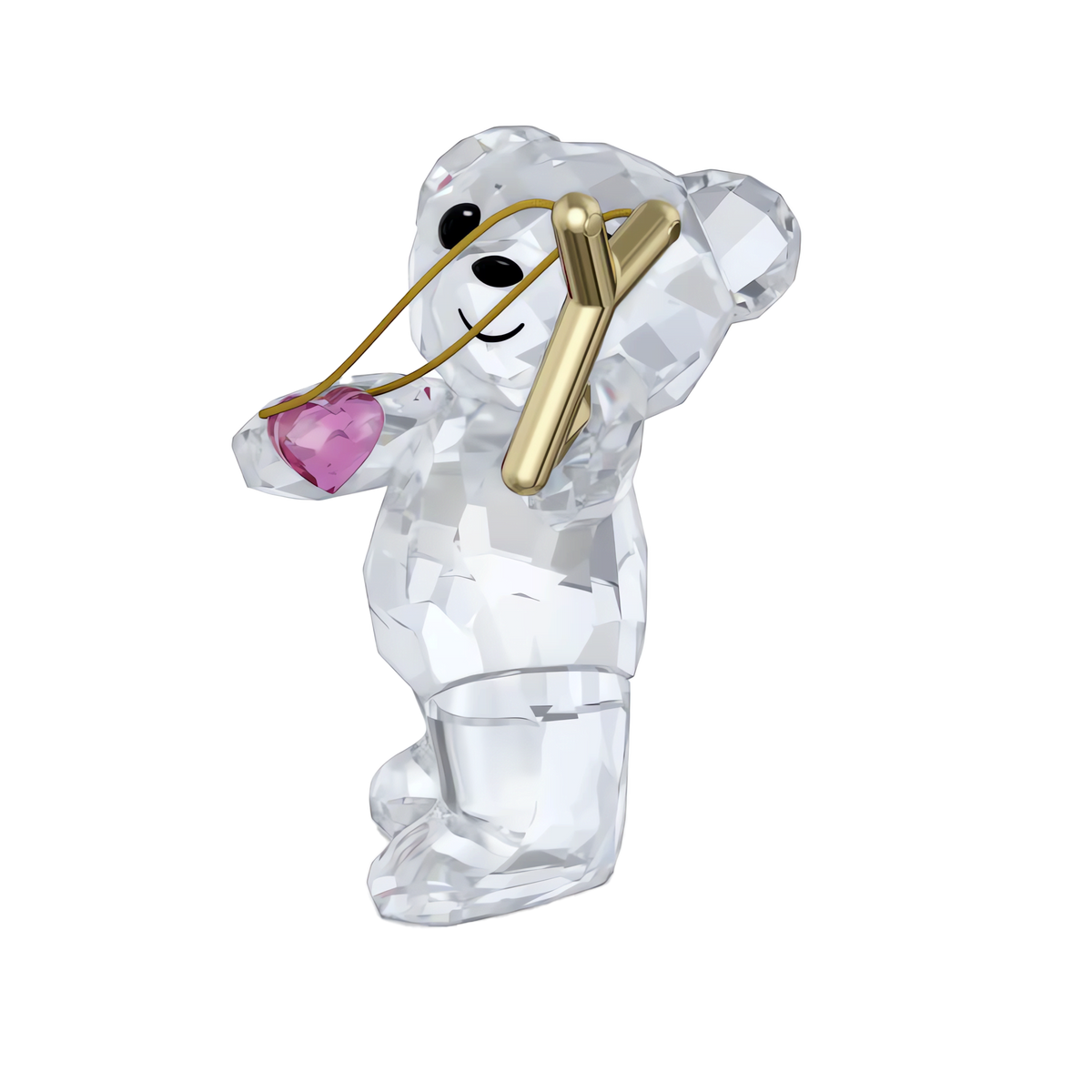 The Swarovski Kris Bear Sending you Love collectible by Swarovski features a clear crystal teddy bear standing upright and smiling, holding a gold-tone slingshot aimed at a sparkling pink crystal heart. Inspired by the iconic Kris Bear design, this charming figurine makes an ideal Valentine’s gift and is beautifully showcased against a plain white background.