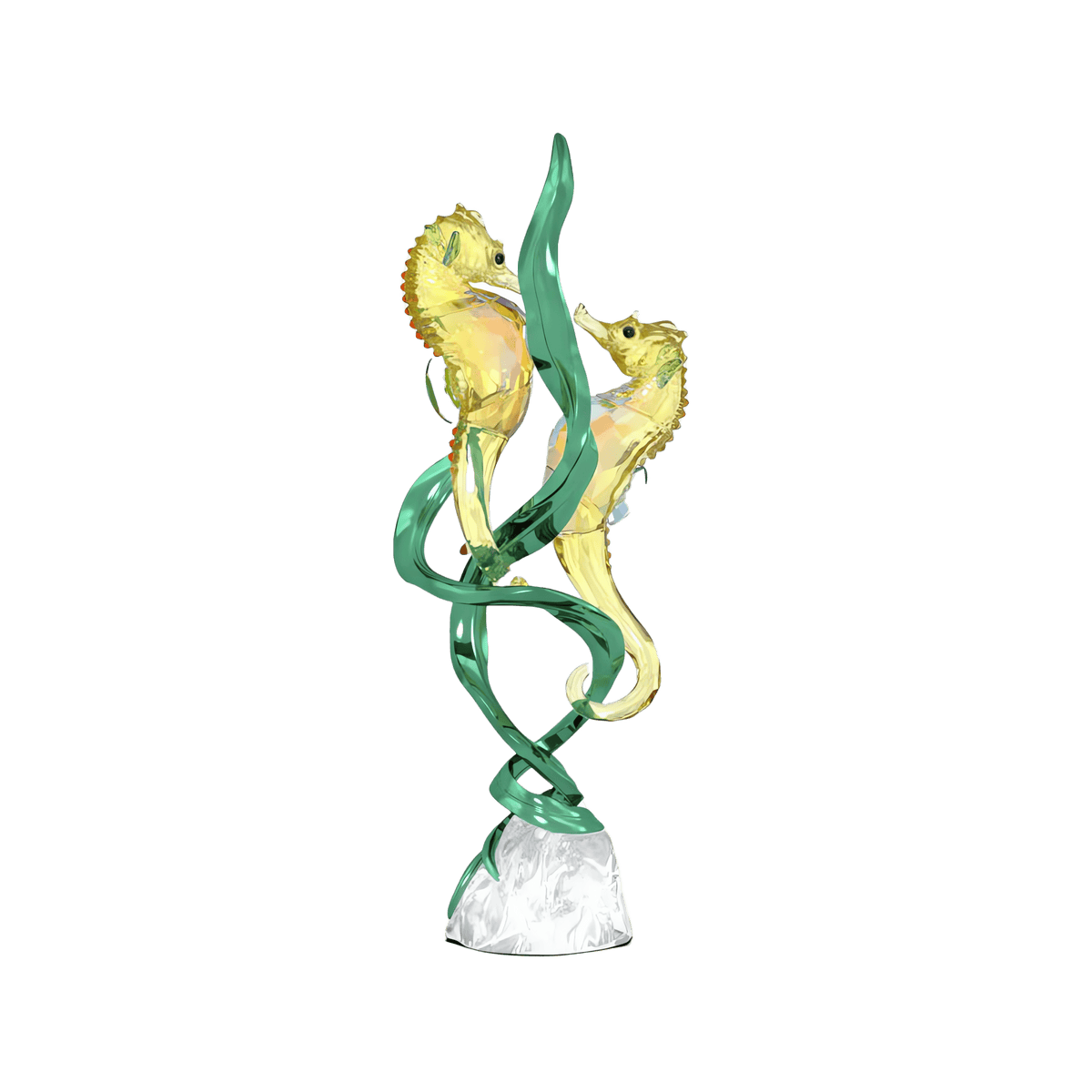 Two glass seahorses with yellow accents face each other, intertwined with green glass seaweed, all mounted on a clear, textured base. Reminiscent of the elegant craftsmanship seen in the Swarovski Idyllia SCS Annual Edition 2025 Seahorses by Swarovski, this piece captures the delicate beauty of seahorses against a plain white background.