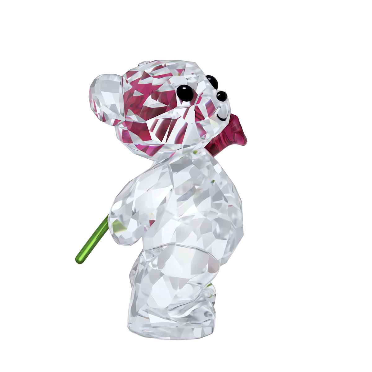 The Swarovski Kris Bear A Rose with Love figurine by Swarovski features a charming crystal teddy bear, adorned with a pink bow tie and holding a green-stemmed flower behind its back—an enchanting piece set against a white background, making it the perfect Valentine’s gift to express heartfelt affection.