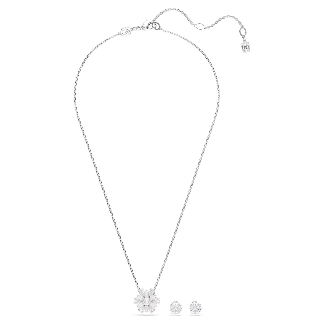 Introducing the Swarovski Idyllia Necklace and Earrings Set by Swarovski, showcasing a delicate silver necklace adorned with a floral pendant and matching stud earrings, each embellished with clear Swarovski Zirconia stones. The necklace features an adjustable chain and elegant rhodium plating, enhancing its sophisticated design.