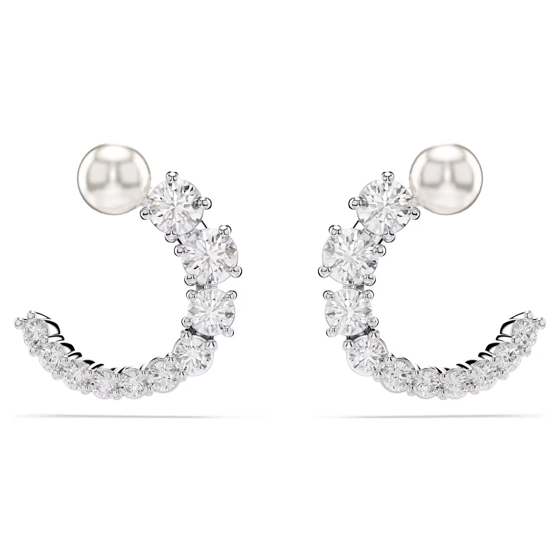 The Swarovski Matrix Hoop Earrings are crescent-shaped, embellished with small round Swarovski Zirconia. A rhodium-plated silver stud tops each earring, with the stones arranged in a row to form an elegant curve against a plain white background.