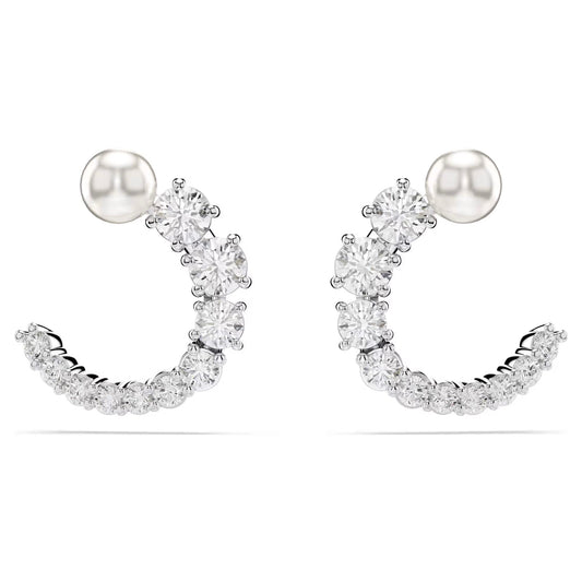 The Swarovski Matrix Hoop Earrings are crescent-shaped, embellished with small round Swarovski Zirconia. A rhodium-plated silver stud tops each earring, with the stones arranged in a row to form an elegant curve against a plain white background.