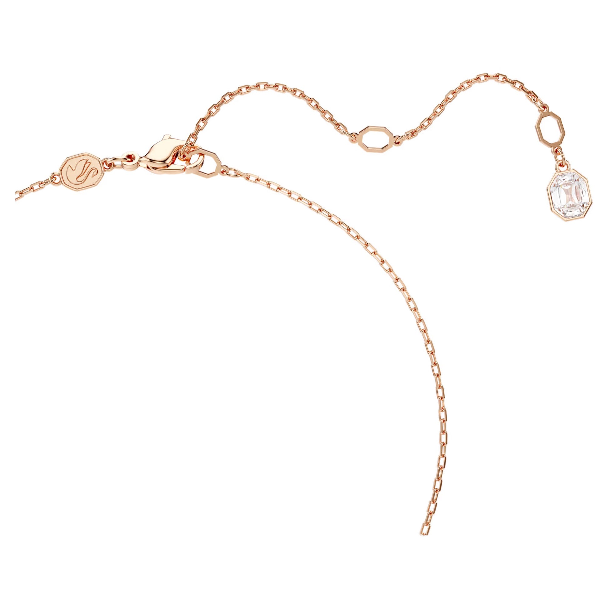 This exquisite rose gold-tone plated necklace pendant, part of the Constella collection by Swarovski, features an adjustable clasp. It is adorned with a small hexagonal charm and a clear, faceted Swarovski Zirconia at one end, offering an elegant touch.