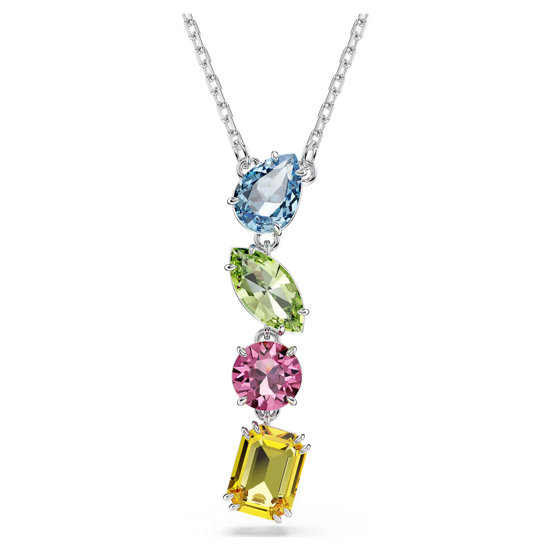 Swarovski's Gema Multicoloured Y Necklace Pendant showcases a silver necklace with a pendant adorned by four distinct gemstones, each in unique shapes and colors: a teardrop-shaped blue stone, an oval green Gema family gemstone, a round pink stone, and a square yellow jewel—all evoking the luxury of fine Swarovski crystals.