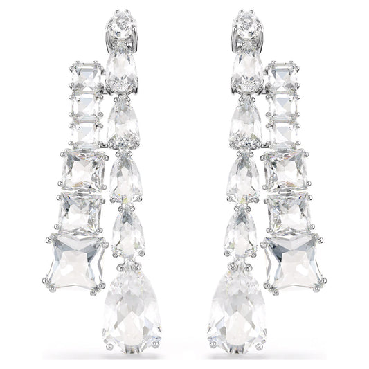 The Swarovski Matrix Drop Earrings are a stunning piece from the Swarovski brand, showcasing an array of large, sparkling clear crystals elegantly set in silver. The design incorporates various shapes to create a cascading effect, making them ideal for formal occasions or adding a touch of glamour to any outfit.