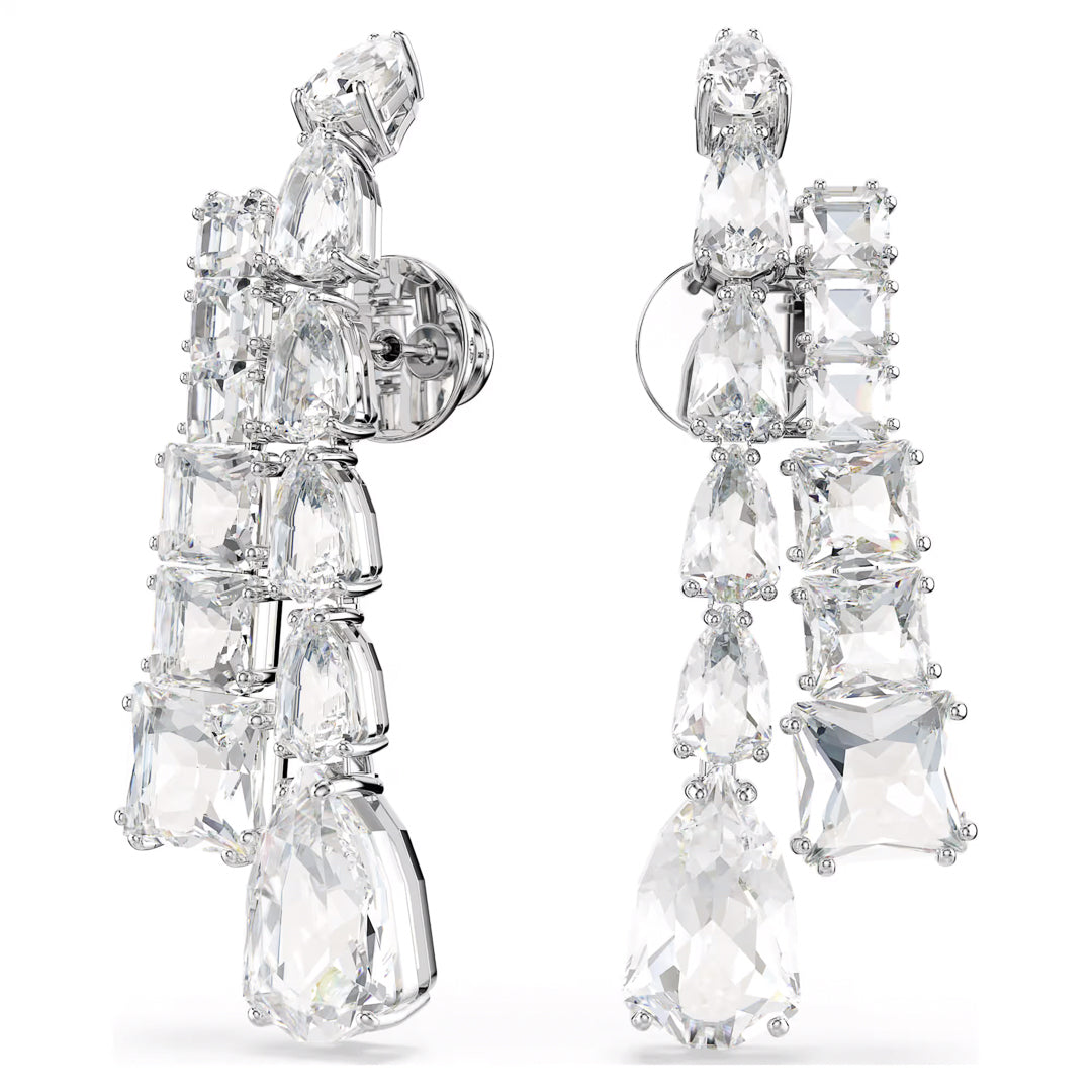 A luxurious and elegant pair of Swarovski Matrix Drop Earrings features a cascading design with variously shaped clear crystals set in silver-toned metal.