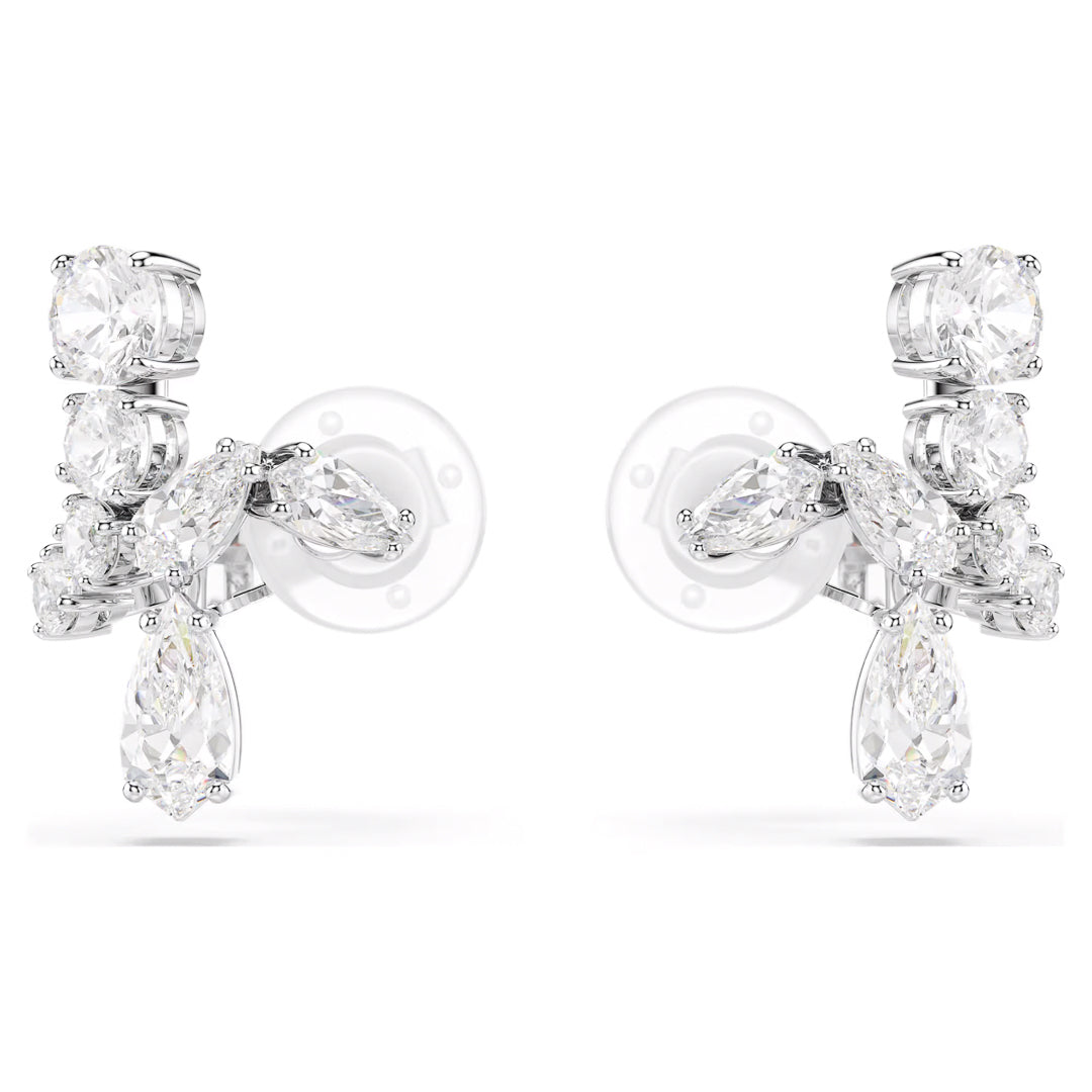 A pair of Swarovski Matrix Clip Earrings from Swarovski, elegantly showcasing multiple sparkling diamonds and Swarovski Zirconia in various cuts, set in a symmetrical design. These earrings have a shiny silver backing that reflects light to enhance their brilliance and are rhodium plated for added elegance.