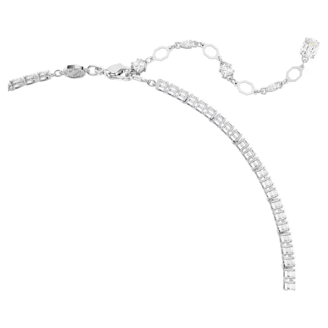 The Swarovski Matrix Y Necklace, offered by the renowned brand Swarovski, is a stunning silver piece embellished with sparkling diamonds and dazzling Swarovski Zirconia. It features a series of links and an adjustable chain that ends in a shimmering diamond charm, all set against a white background.