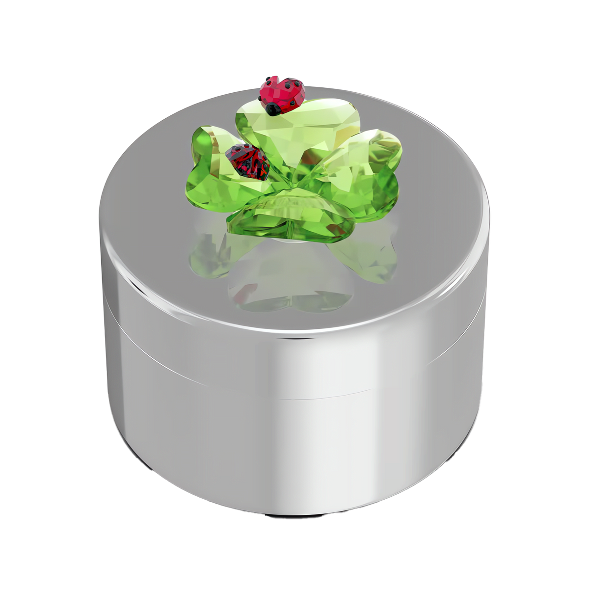 The Swarovski Idyllia Clover and Ladybug Decorative Box is a round silver jewelry box adorned with a green crystal frog and two small red ladybugs on its lid, all set against a pristine white background—a delightful piece for any Swarovski Canada collector.
