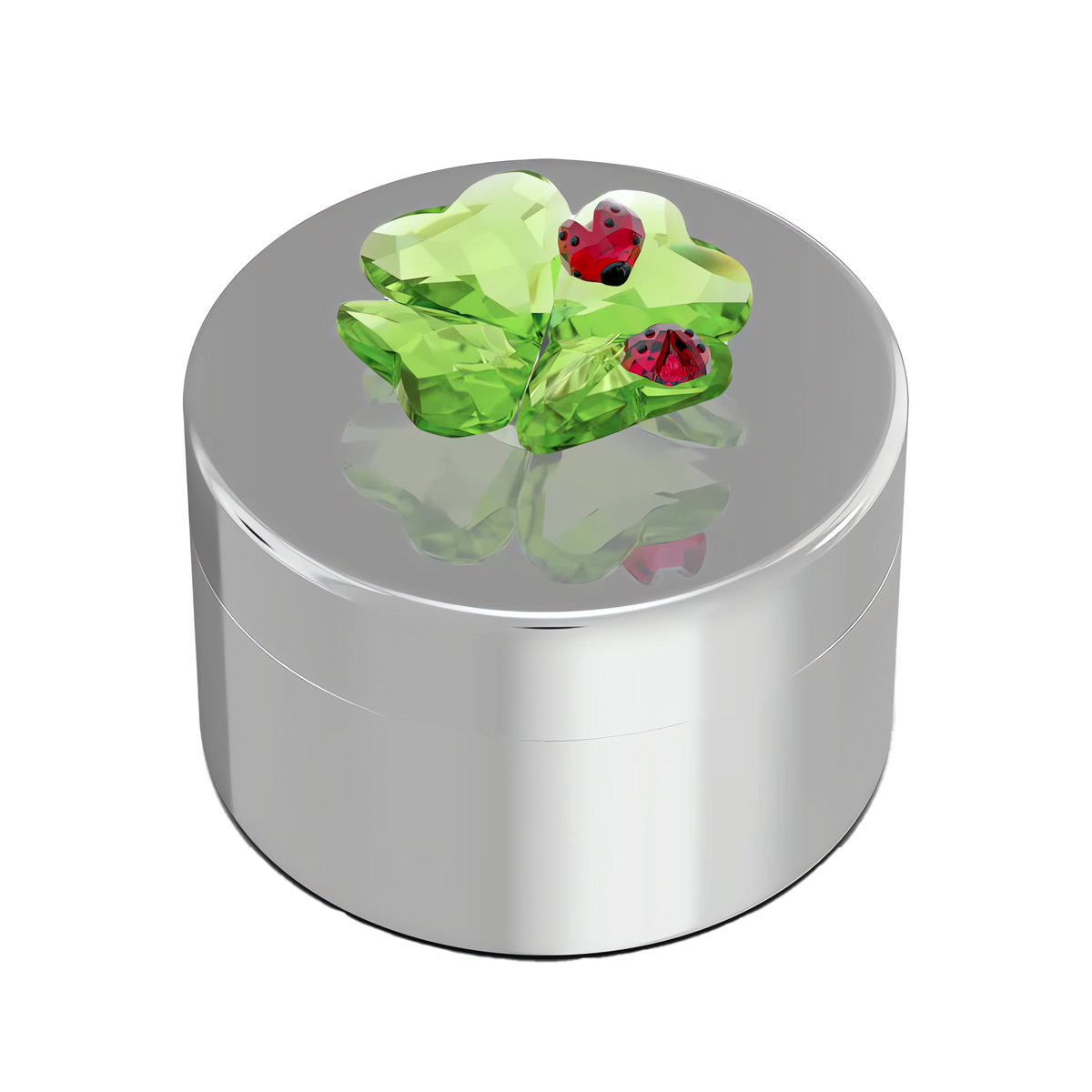 The Swarovski Idyllia Clover and Ladybug Decorative Box by Swarovski showcases a shiny silver round design, featuring a striking green crystal four-leaf clover and two red ladybugs on its lid, set against a white background. Drawing inspiration from the enchanting whimsy of the Idyllia collection, this piece adds a magical touch to any space.