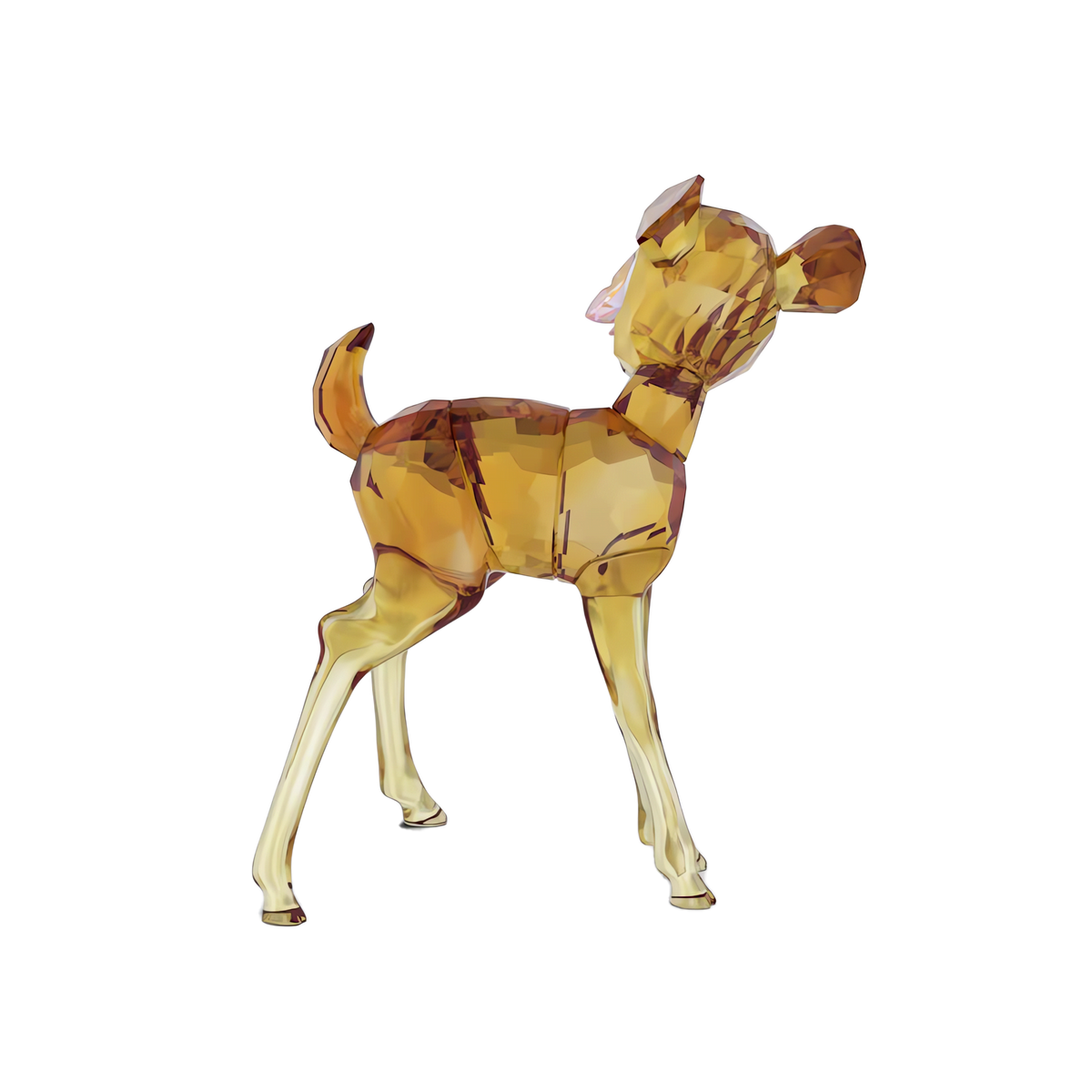 A faceted glass figurine crafted by Swarovski, the Swarovski Disney Classics Bambi, stands gracefully on four legs with its tail slightly raised and gaze uplifted. Rendered in transparent glass tinted with amber and gold hues, this piece captures the iconic Bambi design in signature Swarovski crystal artistry against a white background.