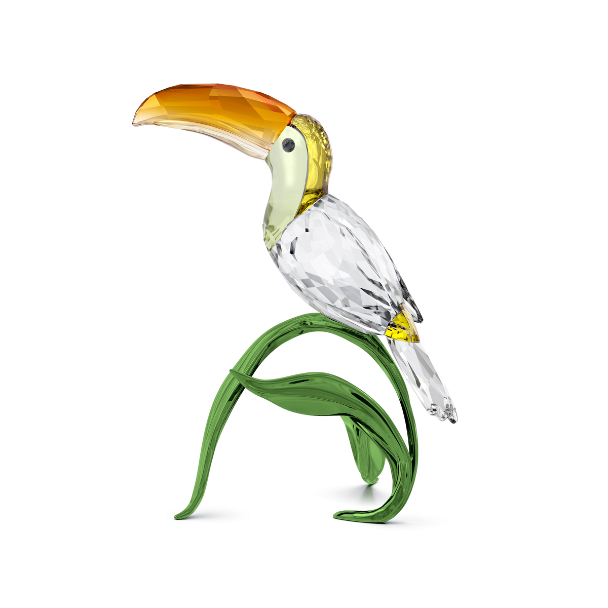 The Swarovski Idyllia Toucan by Swarovski features an orange beak, a clear and yellow body, and is perched on green glass leaves. Presented against a plain white background, this exquisite figurine makes a striking addition to any tropical home décor, capturing the vibrant essence of the tropics.