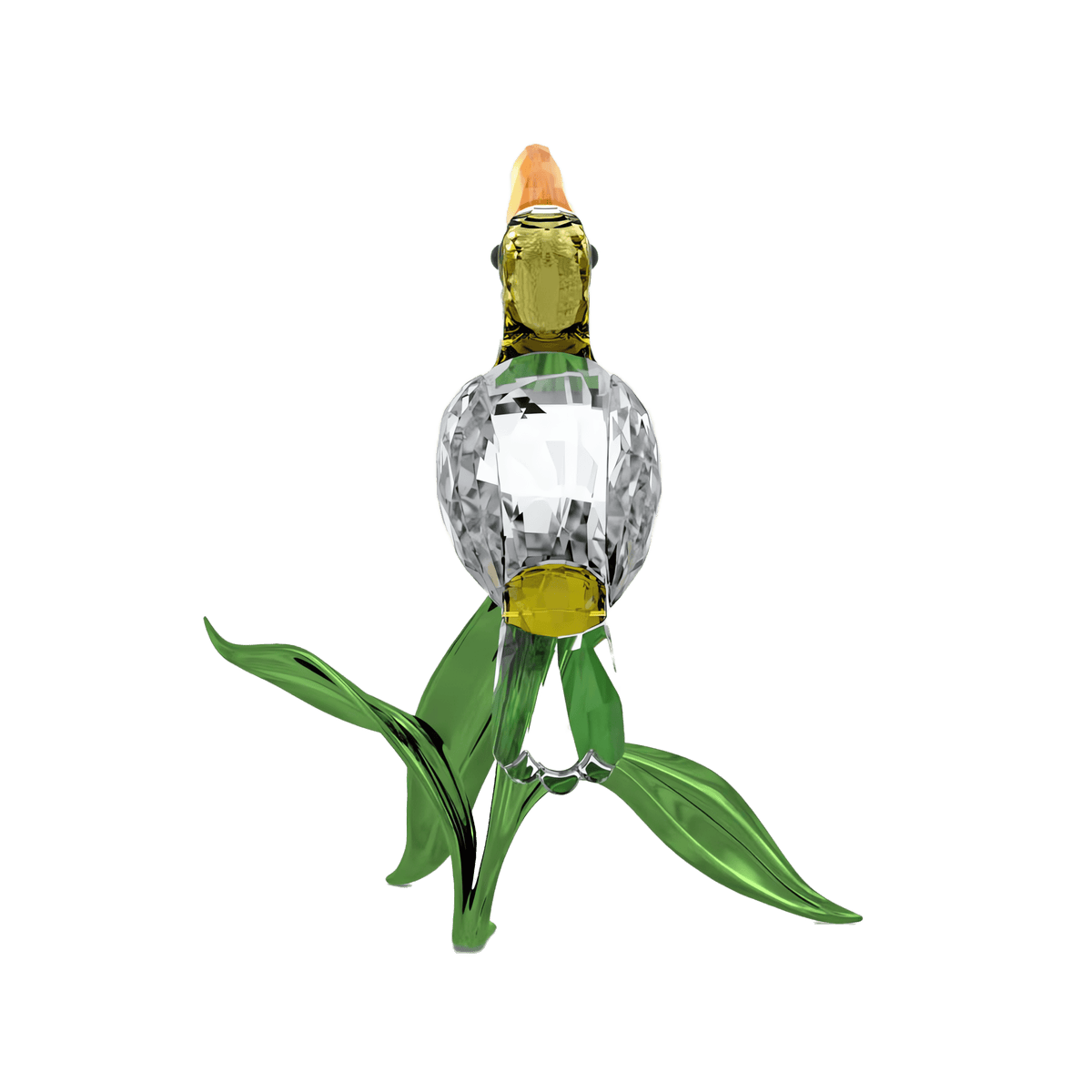 The Swarovski Idyllia Toucan by Swarovski showcases a glass bird with a yellow beak, clear and yellow body, and green leaves, standing upright against a plain white background—perfect for adding a touch of tropical charm to your home décor.