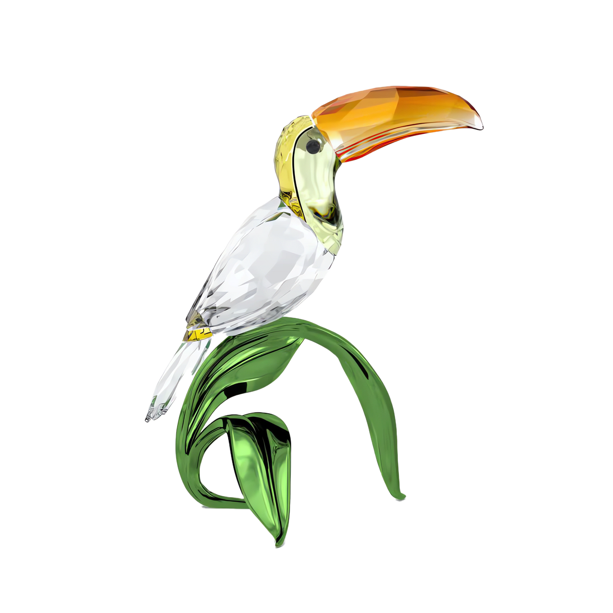 The Swarovski Idyllia Toucan by Swarovski features an orange-beaked crystal toucan perched on a green, glass-like branch against a plain white background, making it an ideal accent for adding tropical flair to any room.