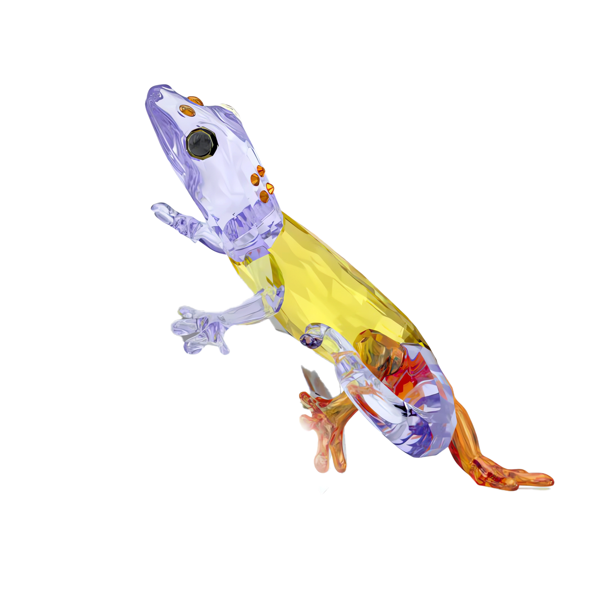 Introduce a striking centerpiece to your home with the Swarovski Idyllia Gecko, a vibrant crystal figurine by Swarovski featuring a yellow body, purple head and limbs, and orange toes, artfully posed as if climbing—perfect for unique home décor or as a standout collectible piece.