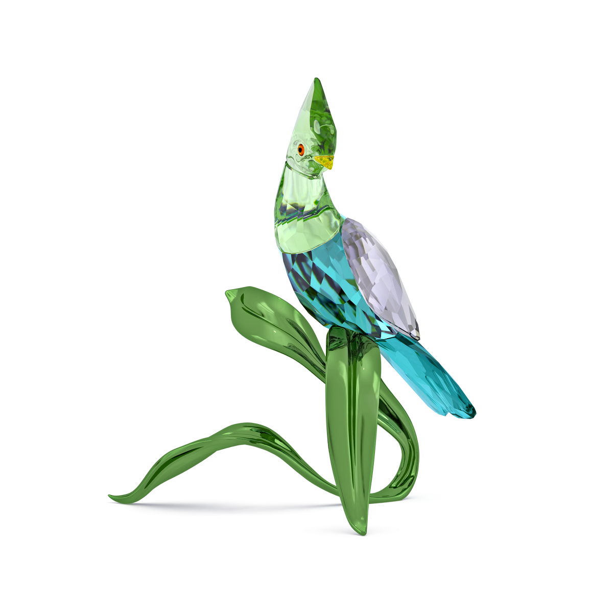 The Swarovski Idyllia Green Turaco by Swarovski is a glass figurine of a colorful bird in green, blue, and purple tones, perched on stylized green glass leaves against a plain white background—making it an elegant home decoration.