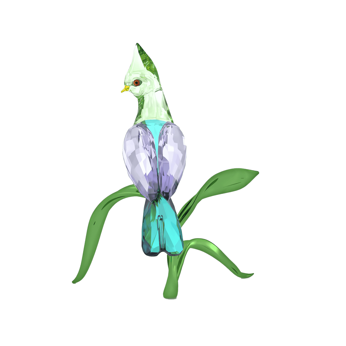 The Swarovski Idyllia Green Turaco by Swarovski is a crystal figurine featuring a glass bird with a green head, purple wings, and blue body perched on delicate green glass leaves, creating a stunning home decoration against the white background.