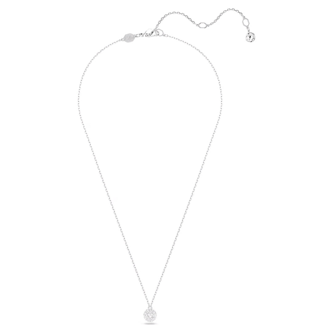 The Swarovski Dextera Necklace Pendant showcases a refined design with its small, round, textured rhodium-plated pendant. This necklace from Swarovski includes an adjustable chain adorned with a delicate charm at the end. Its sophisticated appearance is elevated by sparkling clear crystals when set against a white background.