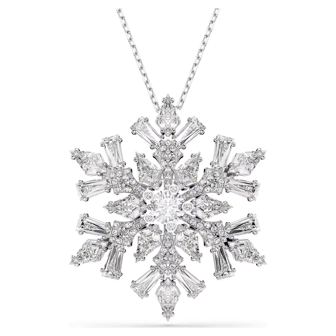 The Swarovski Idyllia Necklace Pendant and Brooch by Swarovski features a silver snowflake shape that is rhodium-plated for extra shine. It is encrusted with sparkling Swarovski Zirconia and hangs gracefully on a delicate chain. The intricate design incorporates various sizes of gemstones, resulting in a dazzling and elegant appearance.