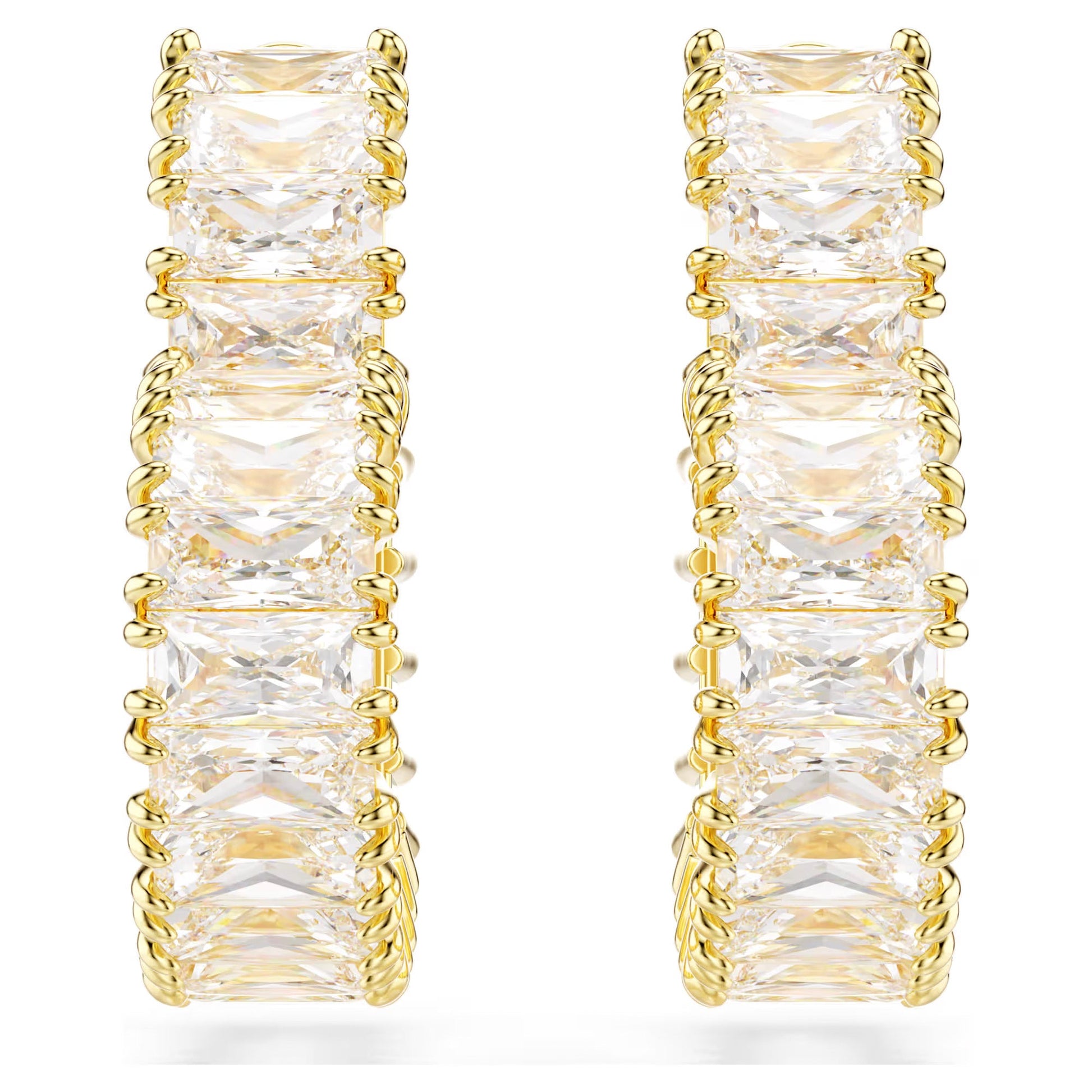 The Swarovski Matrix Heart Hoop Earrings by Swarovski are gold-tone plated hoops featuring a series of square-cut diamonds set in gold prongs. Adorned with sparkling Swarovski Zirconia, they boast a symmetrical and elegant design against a plain white background.