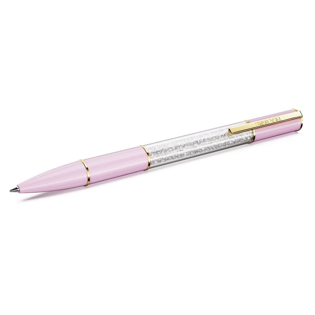 The Swarovski Crystalline Lustre Ballpoint Pen is a pink pen with gold accents, featuring a section filled with clear Swarovski crystals encased in a transparent shell. It's displayed diagonally against a white background, radiating elegance.