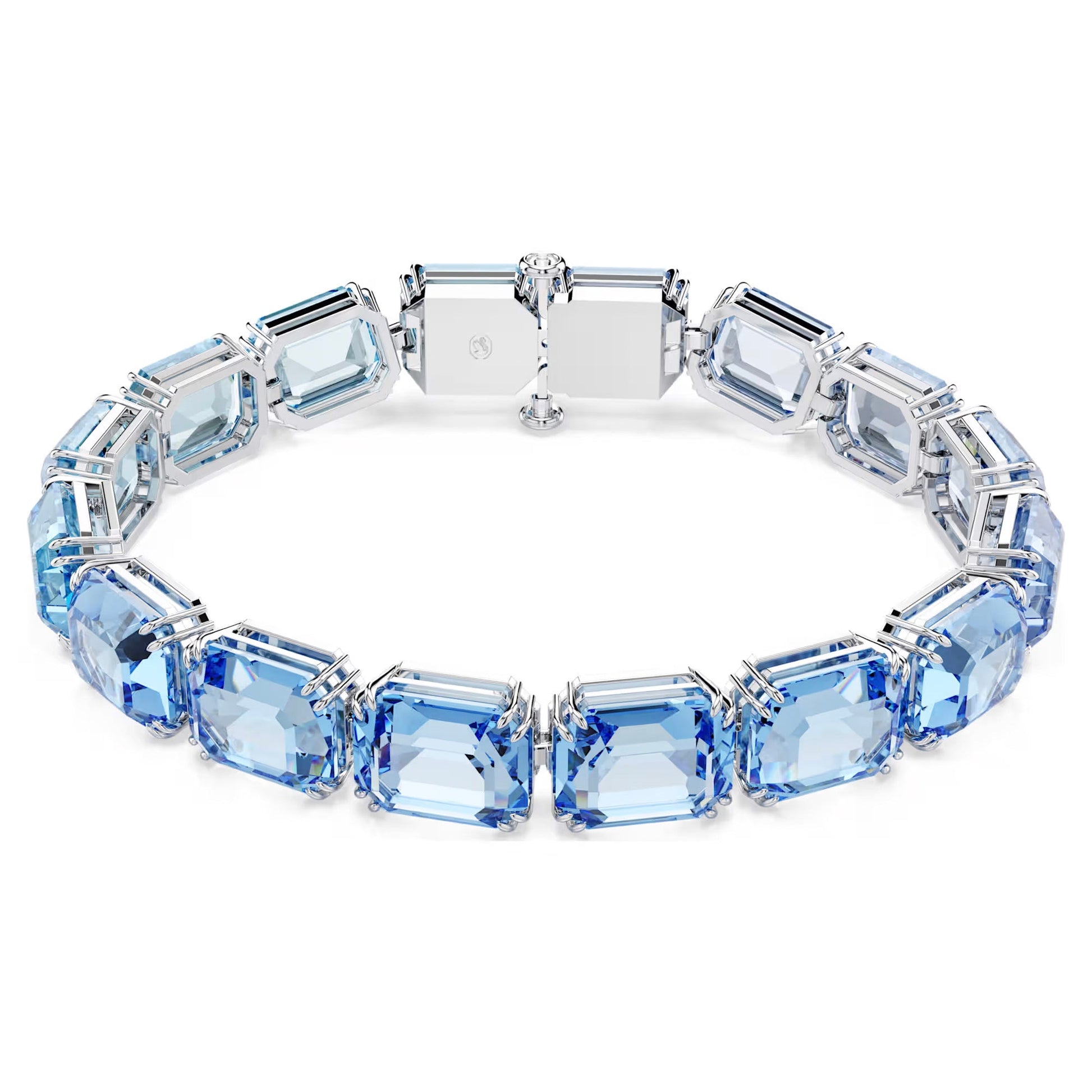 The Swarovski Millenia Tennis Bracelet is a stunning piece that showcases large, rectangular-cut blue gemstones arranged symmetrically. Set in a choice of silver or white gold with a clasp closure, the bracelet features Swarovski's ReCreated crystals, which exhibit subtle variations in shades of blue for an enchanting gradient effect.
