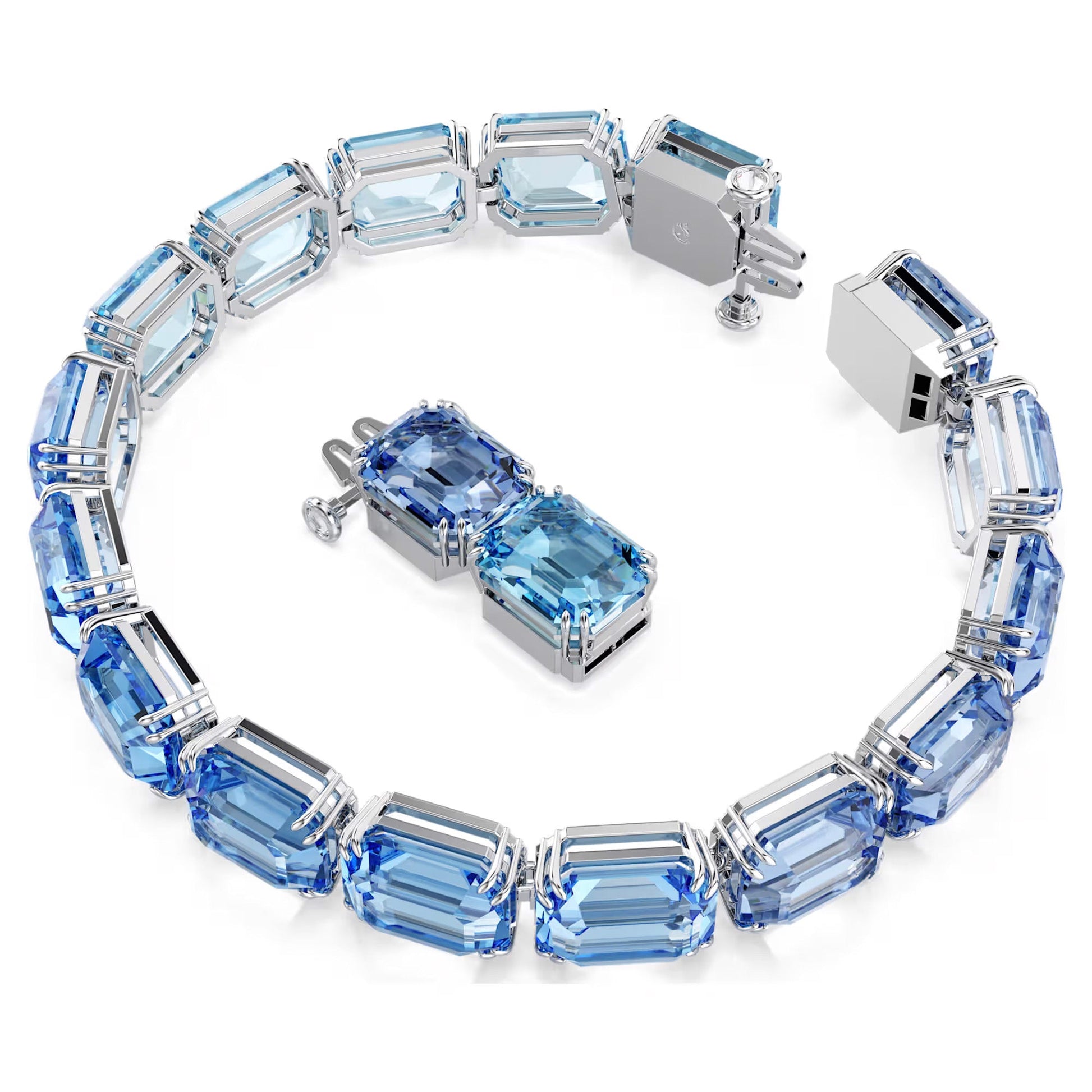 Introducing the Swarovski Millenia Tennis Bracelet: This exquisite piece showcases large, rectangular blue gemstones intricately set within silver links and arranged in a stunning circular design. The bracelet features a partially open clasp for added security, while the high-shine Swarovski ReCreated™ crystals enhance its luminous allure.