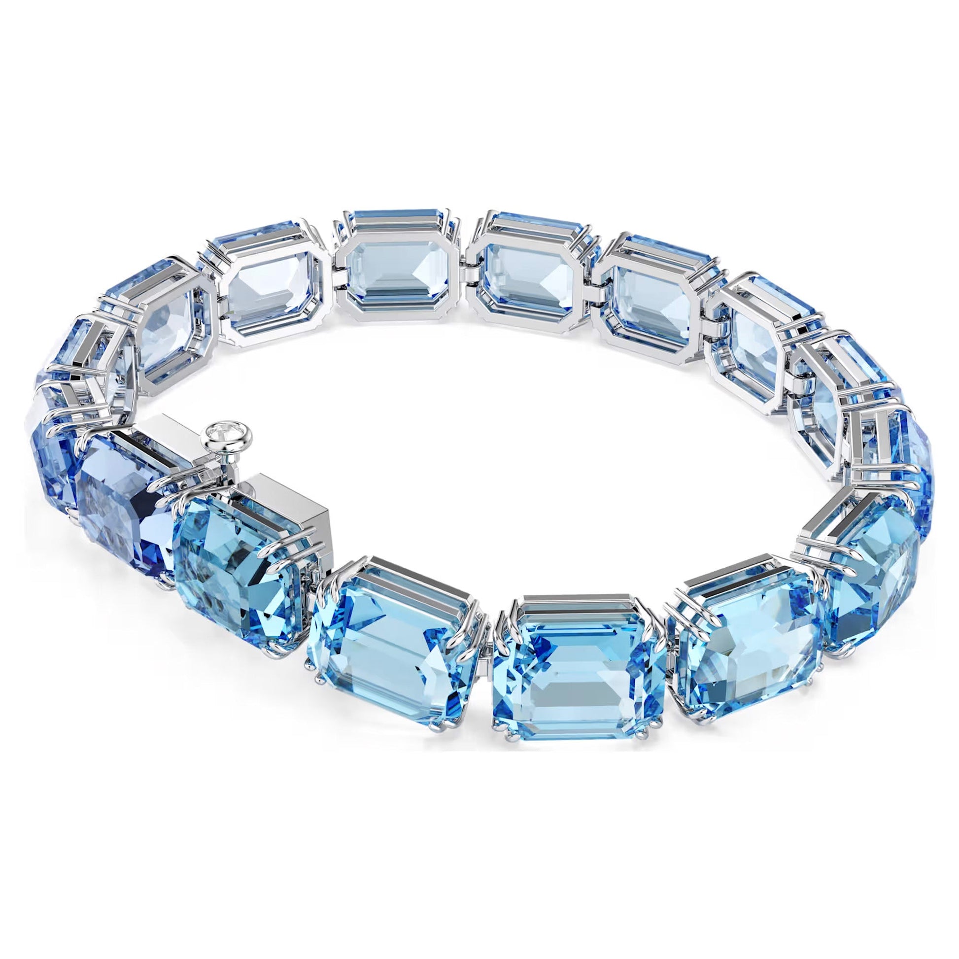 The Swarovski Millenia Tennis Bracelet is an elegant piece featuring large, rectangular blue gemstones crafted from Swarovski's ReCreated crystals set in a silver band. The faceted gems form a circular shape, showcasing a clasp on one side, combining style with sustainable luxury.