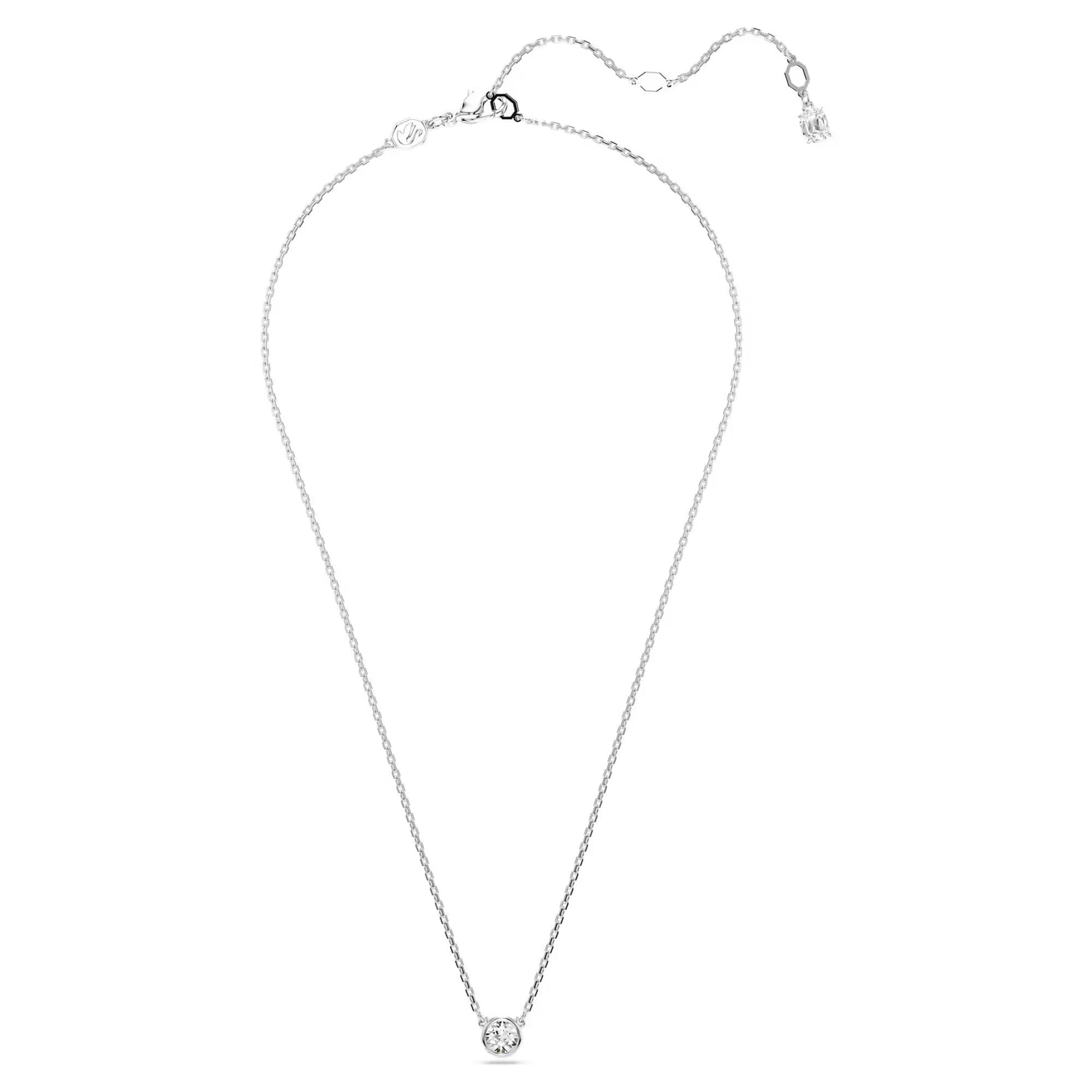 The Swarovski Imber Necklace Pendant by Swarovski showcases a delicate silver chain with a small, round pendant made of Swarovski Zirconia. The rhodium-plated chain comes with an adjustable length, featuring a lobster clasp closure and an extended chain detail that ends in a small charm.