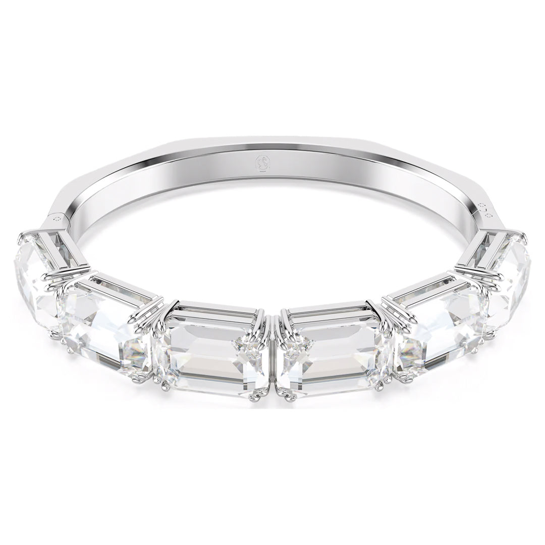 A bangle from the Swarovski Millenia collection showcasing multiple large, octagon-cut crystals set in prongs around the band, displayed against a plain white background, embodying elegance.