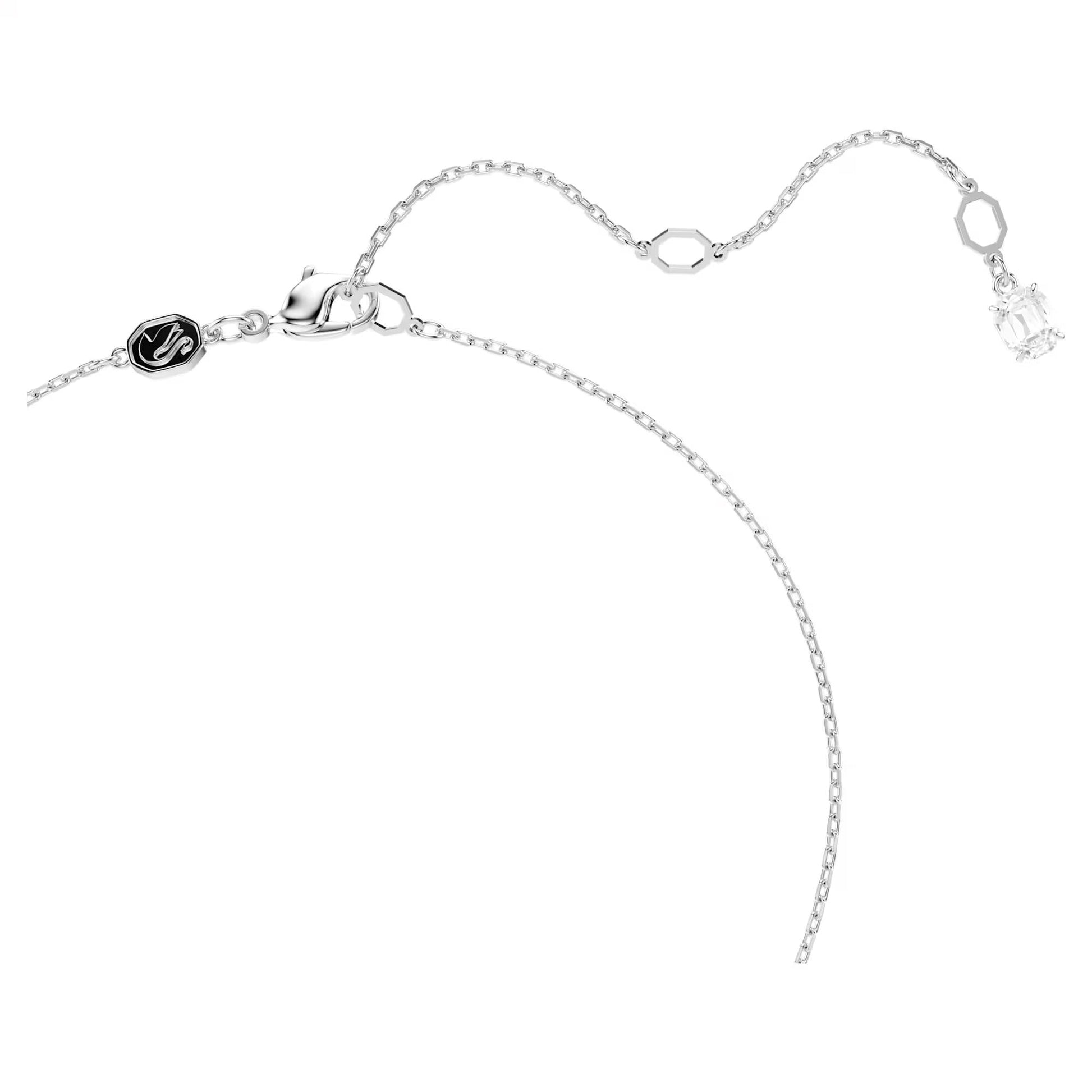 The Swarovski Hyperbola Mixed Cuts Necklace Pendant features a delicate silver chain with an adjustable clasp, adorned with a sparkling rectangular Swarovski Zirconia and includes a round black charm engraved with a letter. This elegant piece of jewelry represents the luxury and craftsmanship synonymous with the Swarovski brand.