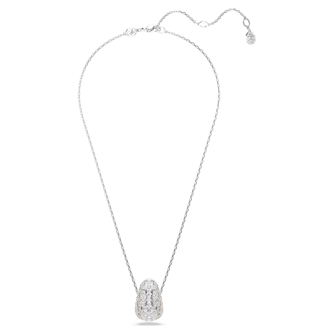 This exquisite piece from the Swarovski Sublima collection features a delicate silver necklace adorned with a stunning teardrop-shaped pendant filled with clear Swarovski crystals against a white backdrop. The thin, adjustable chain guarantees an ideal fit.