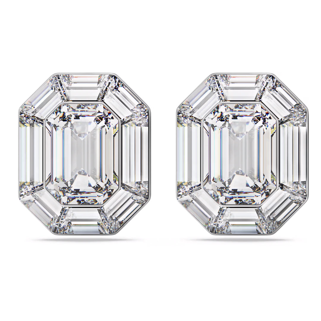 The Swarovski Lucent Clip Earrings feature two dazzling emerald-cut diamonds positioned side by side. Each diamond showcases a classic rectangular shape, echoing an octagon-cut design with beveled corners and step facets that enhance their clarity and brilliance. The earrings are beautifully presented on a plain white background.