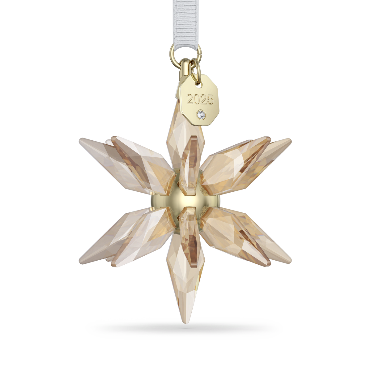 The Swarovski Annual Edition Festive 3D Ornament 2025 features a sparkling gold and crystal star-shaped design with intricate facets, suspended from a white ribbon. This elegant Swarovski ornament includes a gold tag engraved with “2025” and is adorned with a small crystal accent, making it the perfect addition to any celebration.