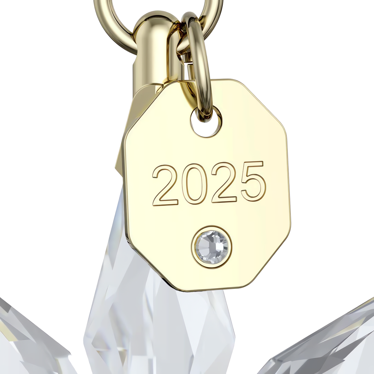 Adorned with a gold octagonal tag engraved “2025” and a small crystal, this Swarovski Annual Edition 3D Ornament 2025 features a clear crystal ornament suspended from a gold ring, making it an elegant and timeless piece from Swarovski.
