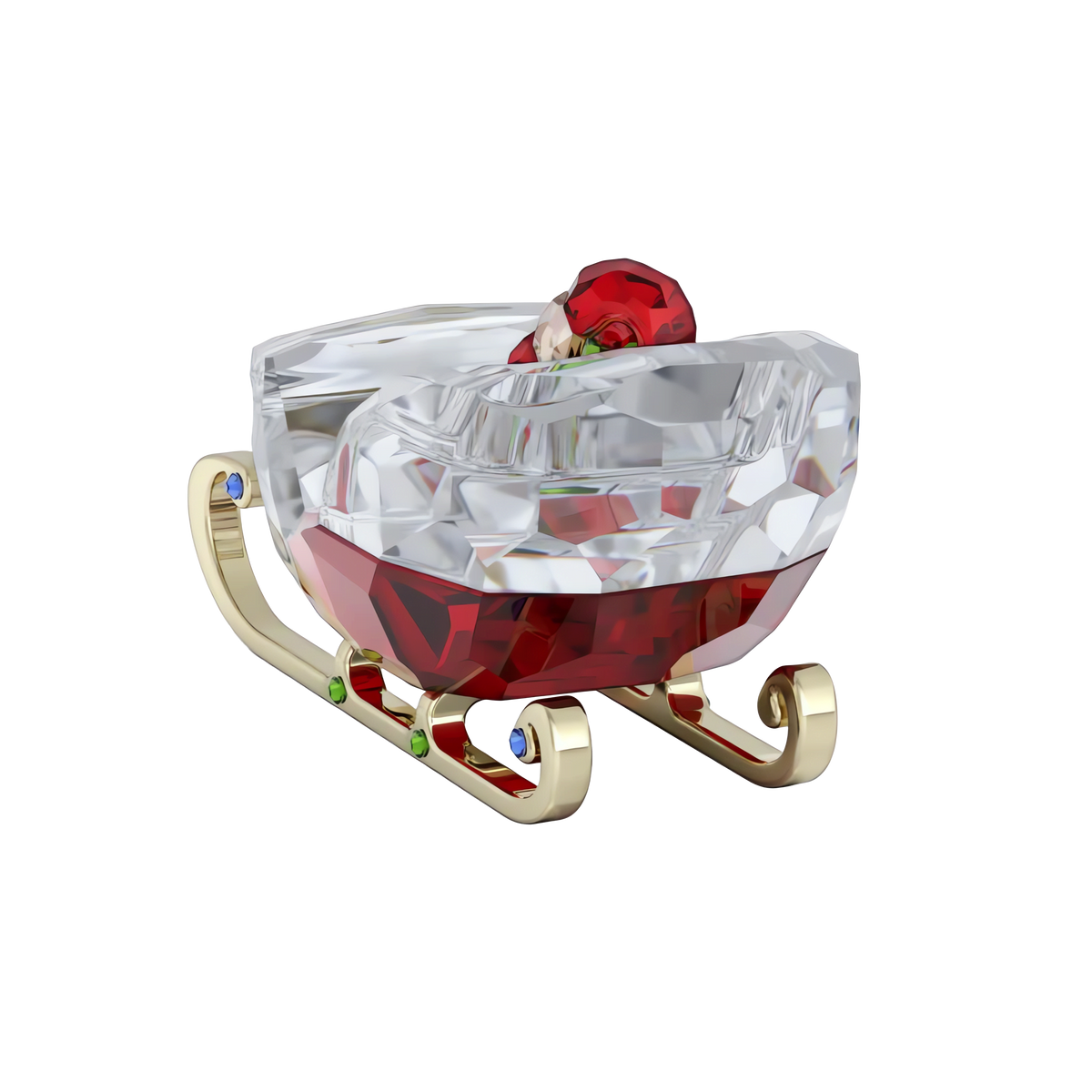 The Swarovski Holiday Cheers Sleigh from Swarovski is a sparkling holiday decoration, featuring gold runners and red and clear crystal details accented with touches of green and blue, beautifully showcased against a white background.