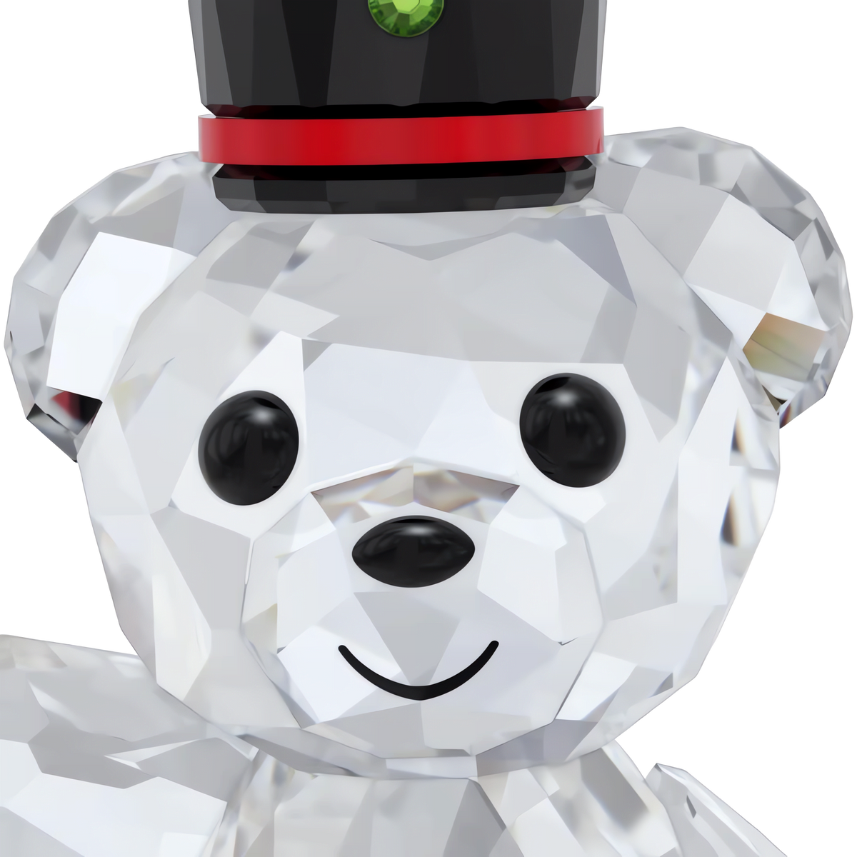 The Swarovski Kris Bear Holiday Annual Edition 2025 by Swarovski is a charming figurine featuring black button eyes, a black nose, a smiling mouth, and a black top hat adorned with a red band and green gem. Its body is expertly crafted from clear, faceted crystal—making it an ideal collectible or gift for the holidays. Available from Swarovski Canada.