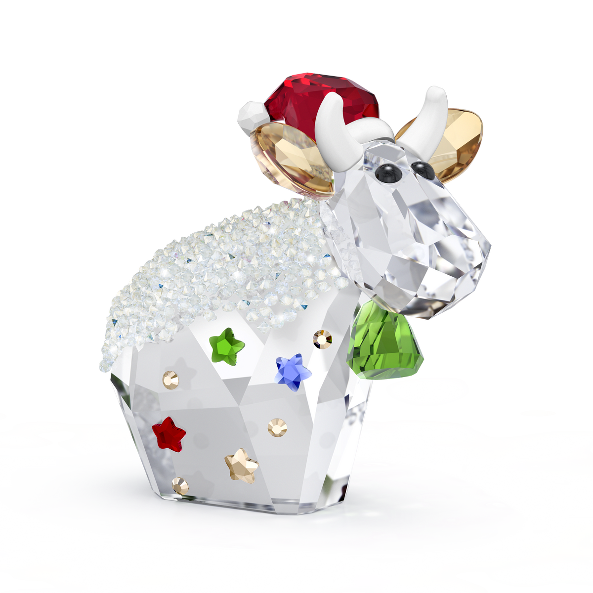 The Swarovski Mo Holiday Annual Edition 2025 figurine by Swarovski features a crystal cow adorned with a green bell, Santa hat, sparkling white back, and colorful star decorations on its body. Presented against a plain white background, this collectible is available from Swarovski Canada.