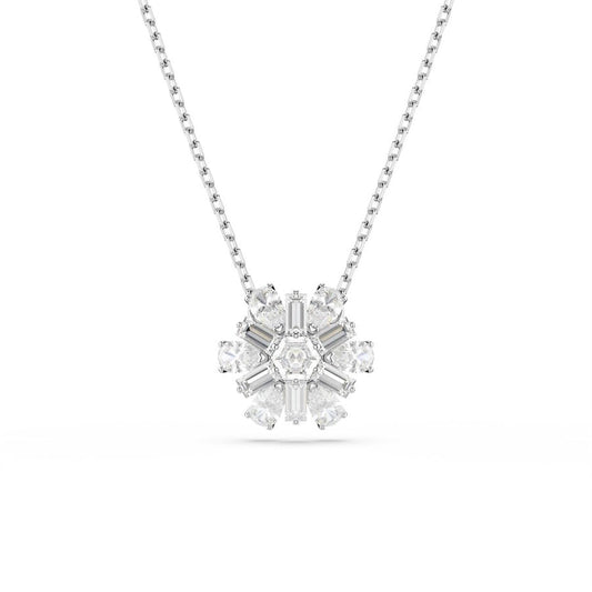 The Swarovski Idyllia Necklace Pendant by Swarovski is a rhodium-plated silver necklace featuring a snowflake-shaped design adorned with sparkling white crystals that are symmetrically arranged around a central stone.