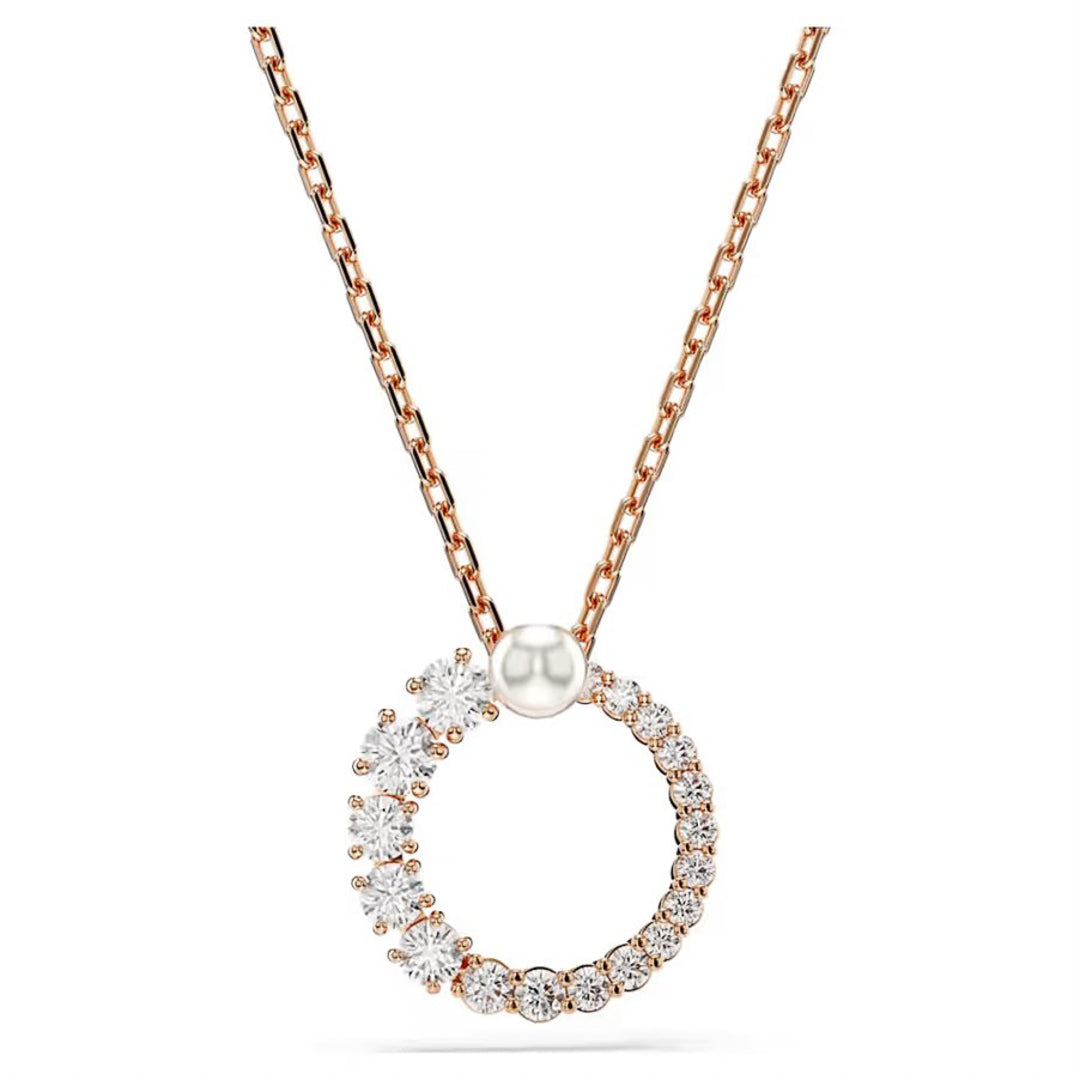 Discover the Swarovski Matrix Crystal Pearl Necklace Pendant, a refined piece from Swarovski adorned with sparkling crystals in varying sizes. This rose gold necklace features a circular pendant and is paired with a delicate, thin chain that enhances its elegant design.