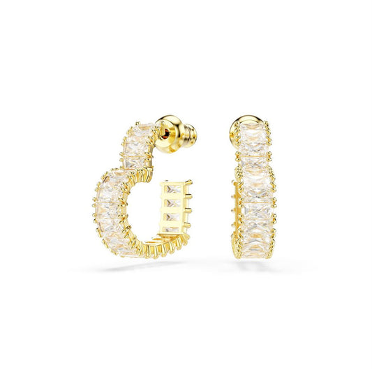The Swarovski Matrix Baguette Crystal Hoop Earrings, designed by Swarovski, feature a row of dazzling square-cut crystals along the outer edge. These rhodium-plated gold hoops display an elegant design, highlighting intricate craftsmanship and offering a luxurious look against a white background.