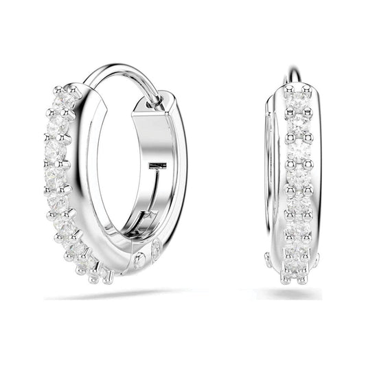 The Swarovski Matrix Hoop Earrings, crafted by Swarovski, are a stunning pair of silver hoops adorned with glimmering Swarovski crystals. One earring is positioned to show the frontal view, while the other reveals its side profile. These rhodium-plated earrings boast a polished finish and feature an intricate design.