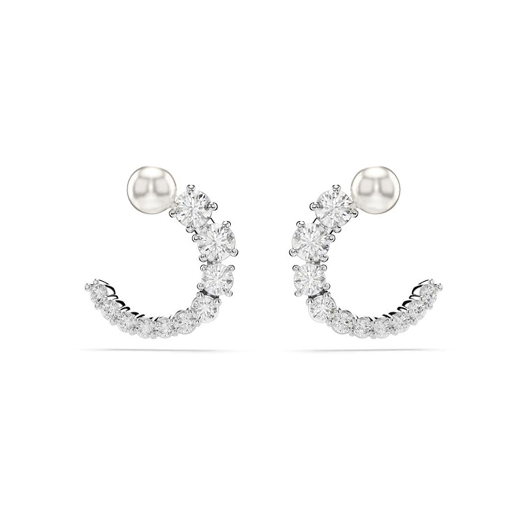 A pair of Swarovski Matrix Crystal Pearl Circular Stud Earrings by Swarovski, featuring an elegant crescent design adorned with sparkling white gemstones attached to a simple round stud.