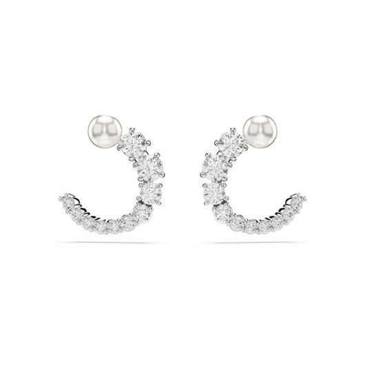 A pair of Swarovski Matrix Crystal Pearl Circular Stud Earrings by Swarovski, featuring an elegant crescent design adorned with sparkling white gemstones attached to a simple round stud.