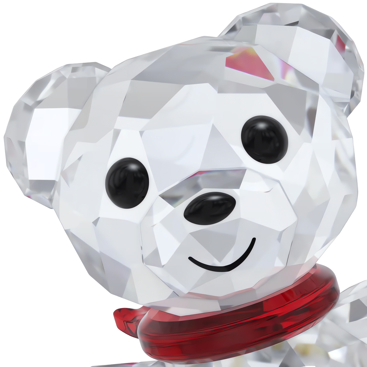 A close-up of the Swarovski Kris Bear 130th Anniversary figurine, featuring faceted crystal craftsmanship, black eyes, a black nose, a smiling mouth, and a red collar around its neck—available at Raffi Jewellers and from Swarovski Canada.