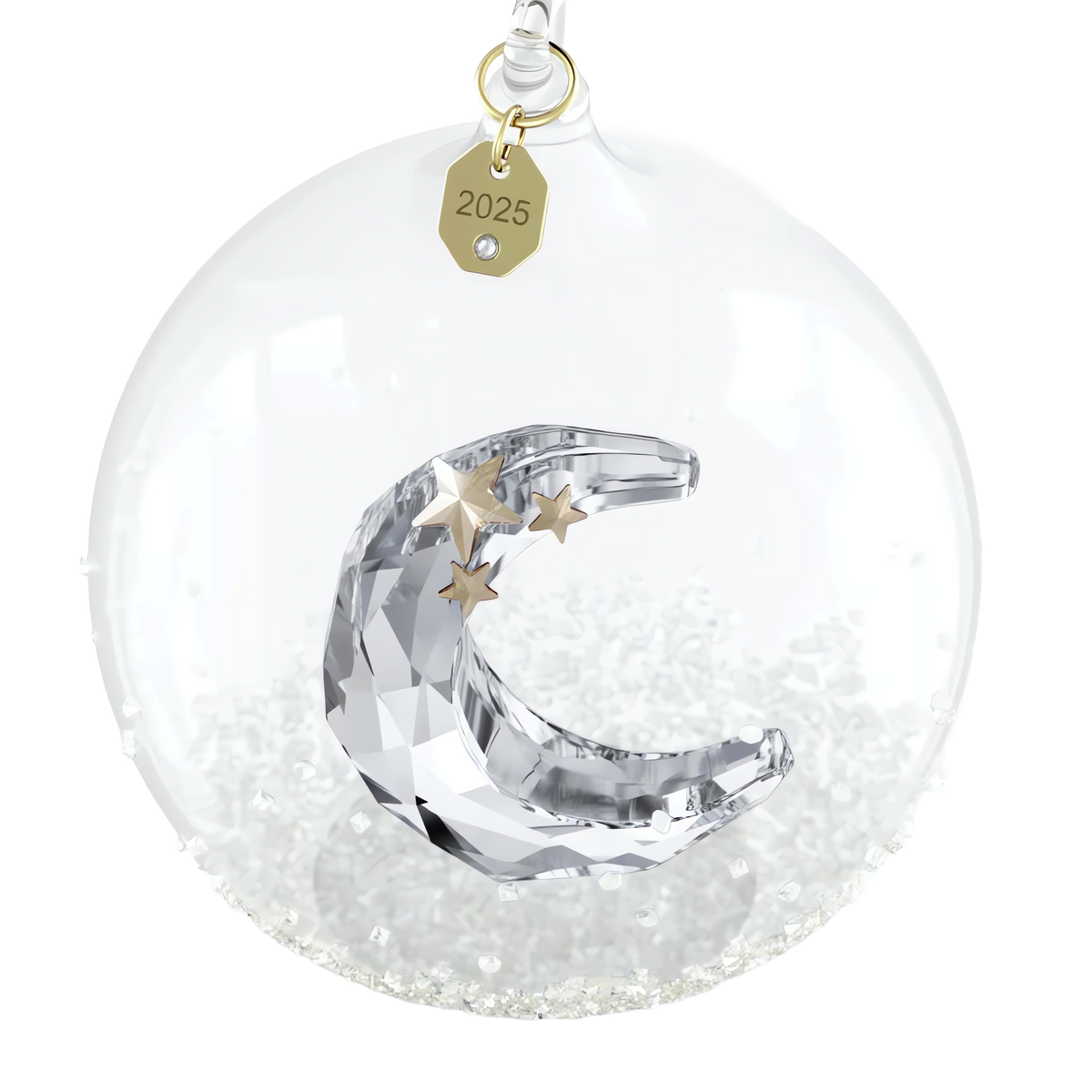 The Swarovski Annual Edition Ball Ornament 2025 features a clear glass design with a faceted crescent moon and three gold stars inside, sparkling white beads at the base, and a gold tag engraved with “2025” attached to the top. This elegant collectible by Swarovski is available at select retailers, including Raffi Jewellers and Swarovski Canada.