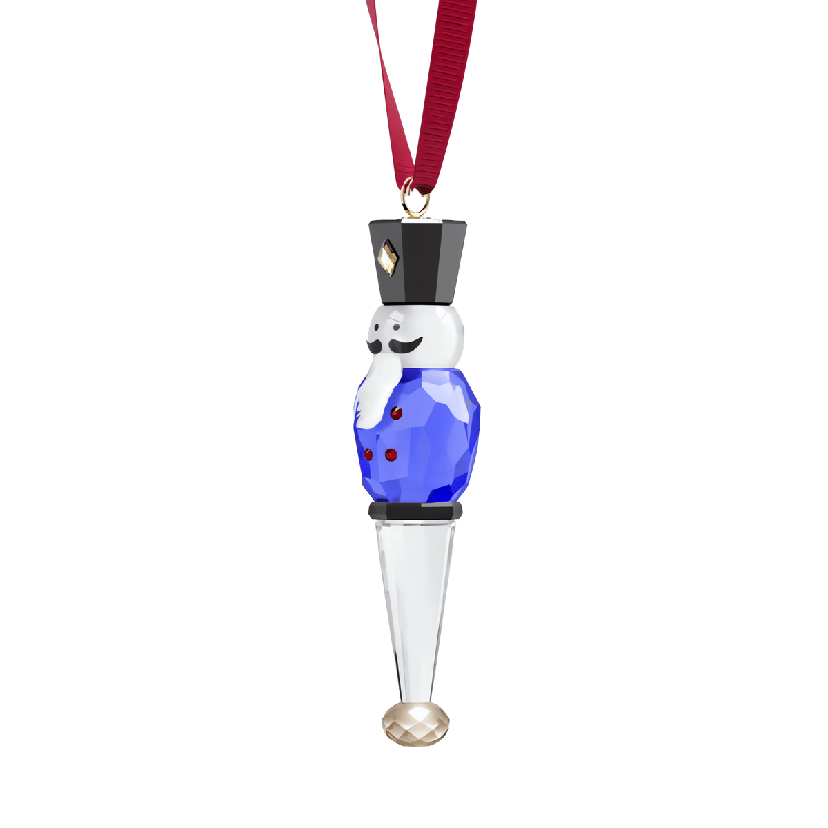 A faceted glass ornament in the shape of a nutcracker, adorned in a blue uniform, hanging from a red ribbon against a white background—the Swarovski Holiday Cheers Nutcracker Ornament by Swarovski is a charming holiday decoration that adds festive décor to any setting.