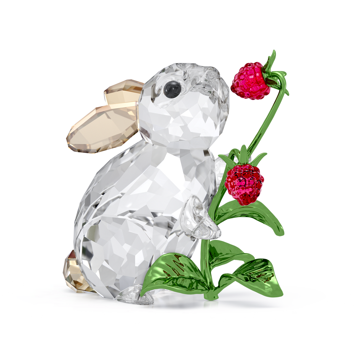 The Swarovski Idyllia Rabbit and Raspberries figurine by Swarovski features a charming crystal rabbit with gold-toned ears, delicately holding a green stem adorned with red raspberries and leaves, set against a white background—an enchanting piece perfect for home décor.