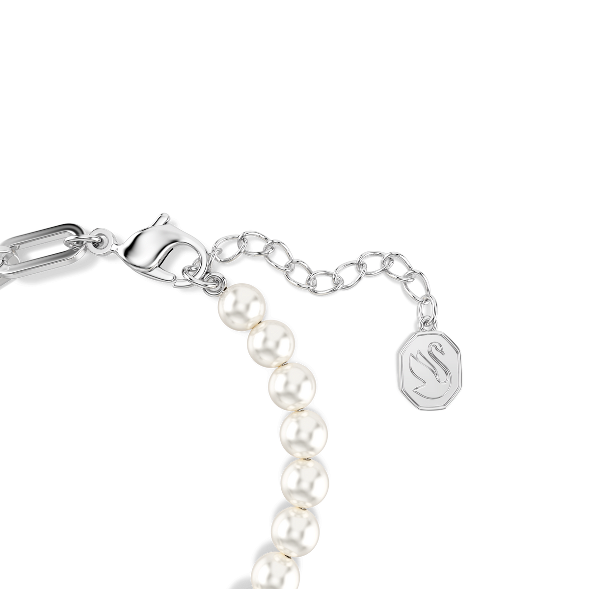 A close-up of the Swarovski Swan bracelet showcases its rhodium-plated finish, featuring luminous crystal pearls, a secure silver lobster clasp, an adjustable chain, and a small rectangular tag engraved with a swan outline. The refined elegance of this design is emblematic of Swarovski’s signature style.